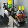 Kitchen sink caddy basket holding a sponge and folded dishcloth